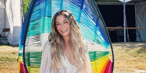 leann rimes sitting on a rainbow swing smiling at austin city limits