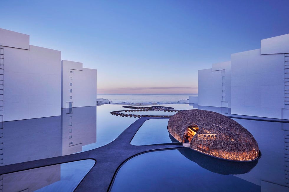 modern architectural design featuring a unique structure and a reflective pool modern architectural design featuring a unique structure and a reflective pool