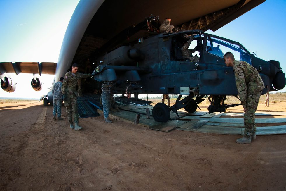soldiers from 1st attack reconnaissance battalion, 82nd combat aviation brigade, down load their ah 64 apache following transport from c 17 globemaster iii, camp mackall, nc, march 17 us army by capt adan cazarez