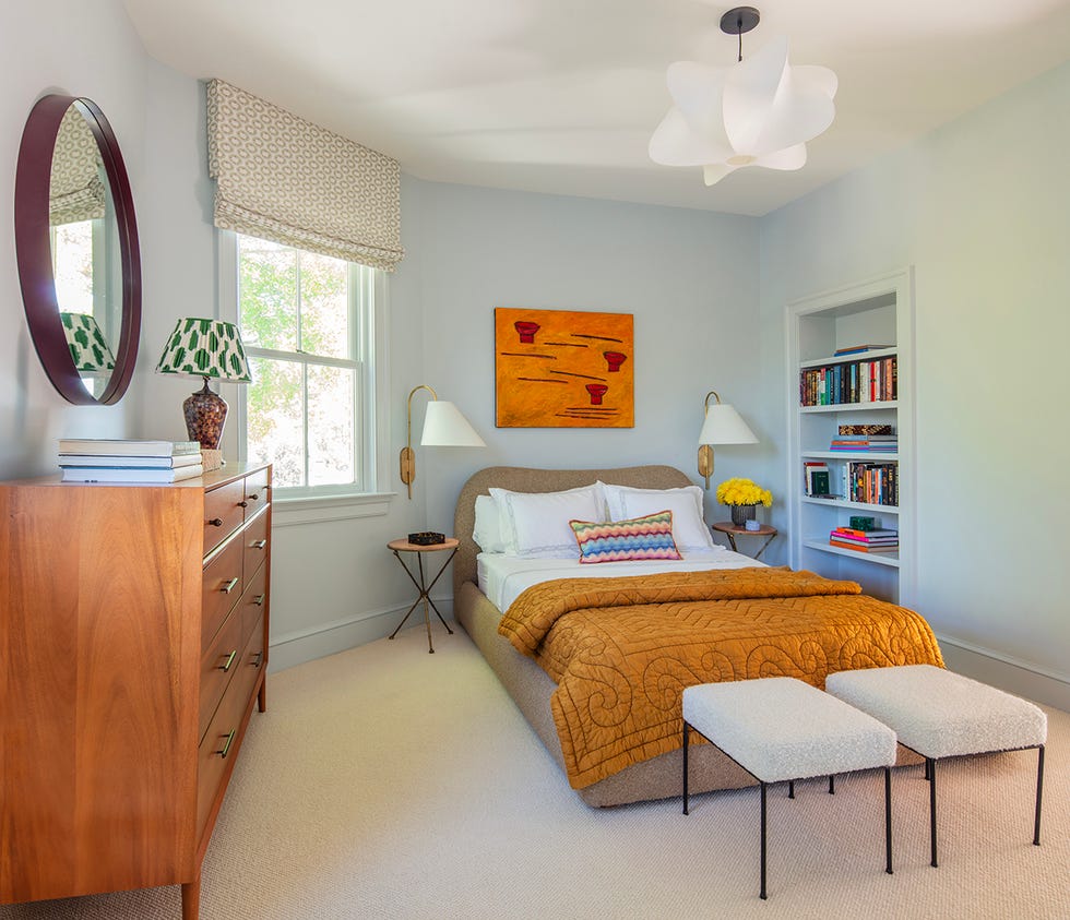 a cozy and modern bedroom featuring built in bookshelf