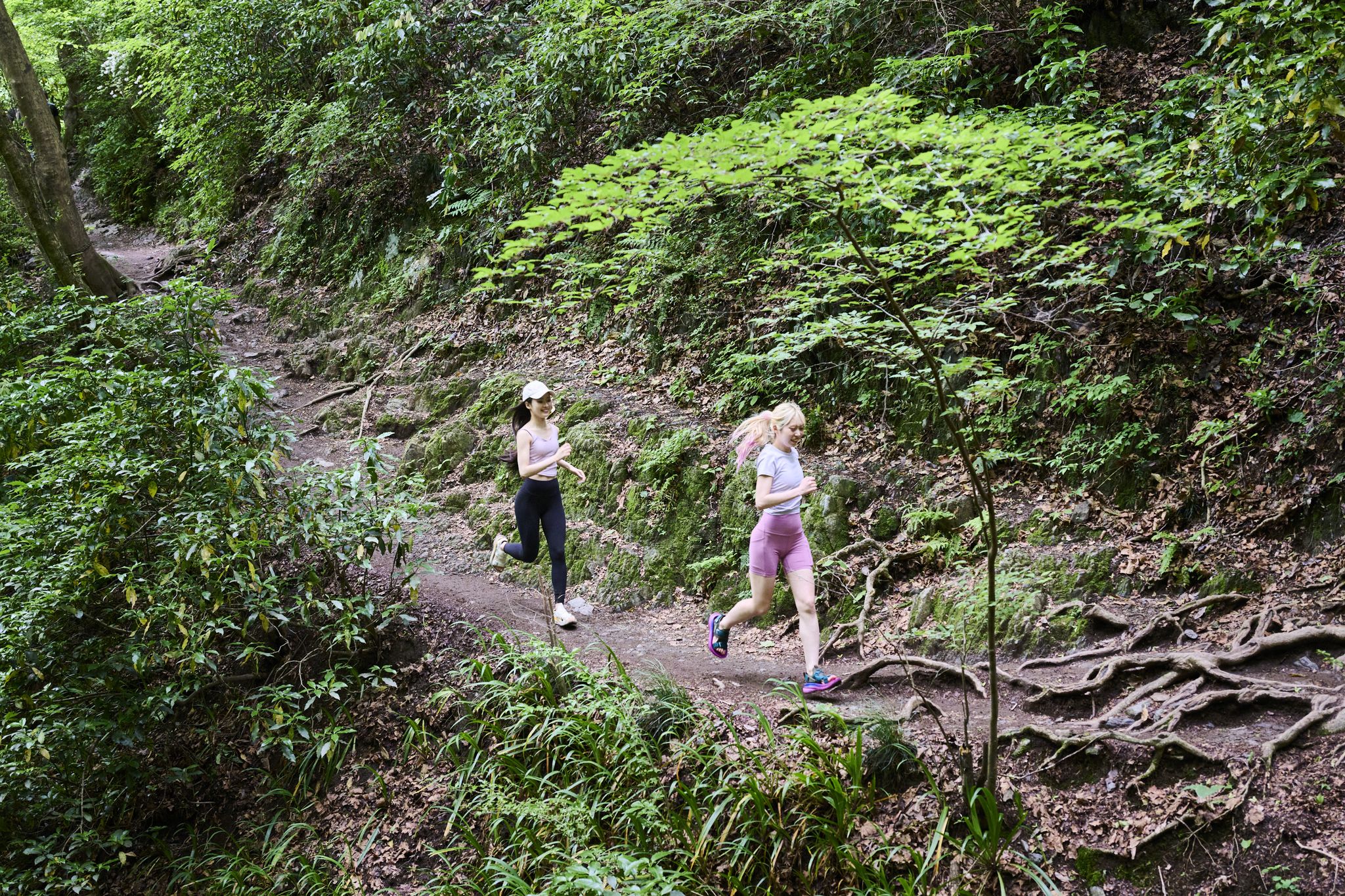 two women walking on a trail