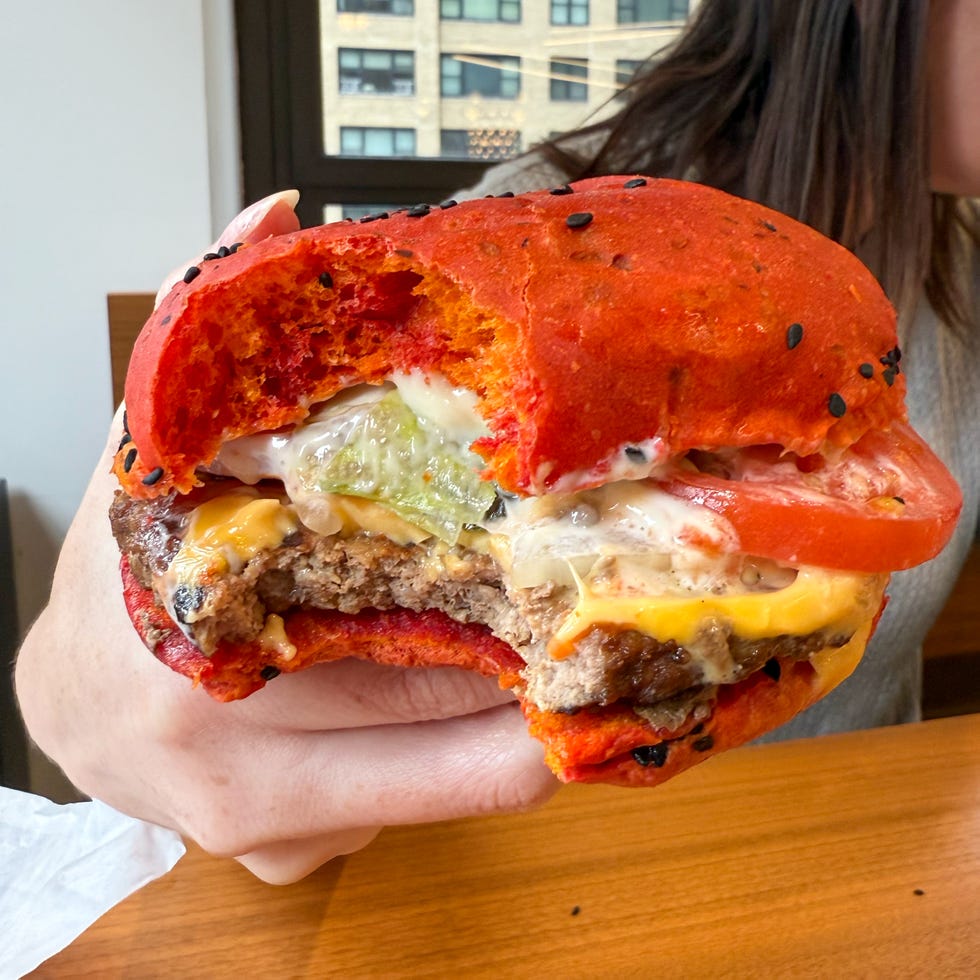 halfeaten burger with a colorful red bun