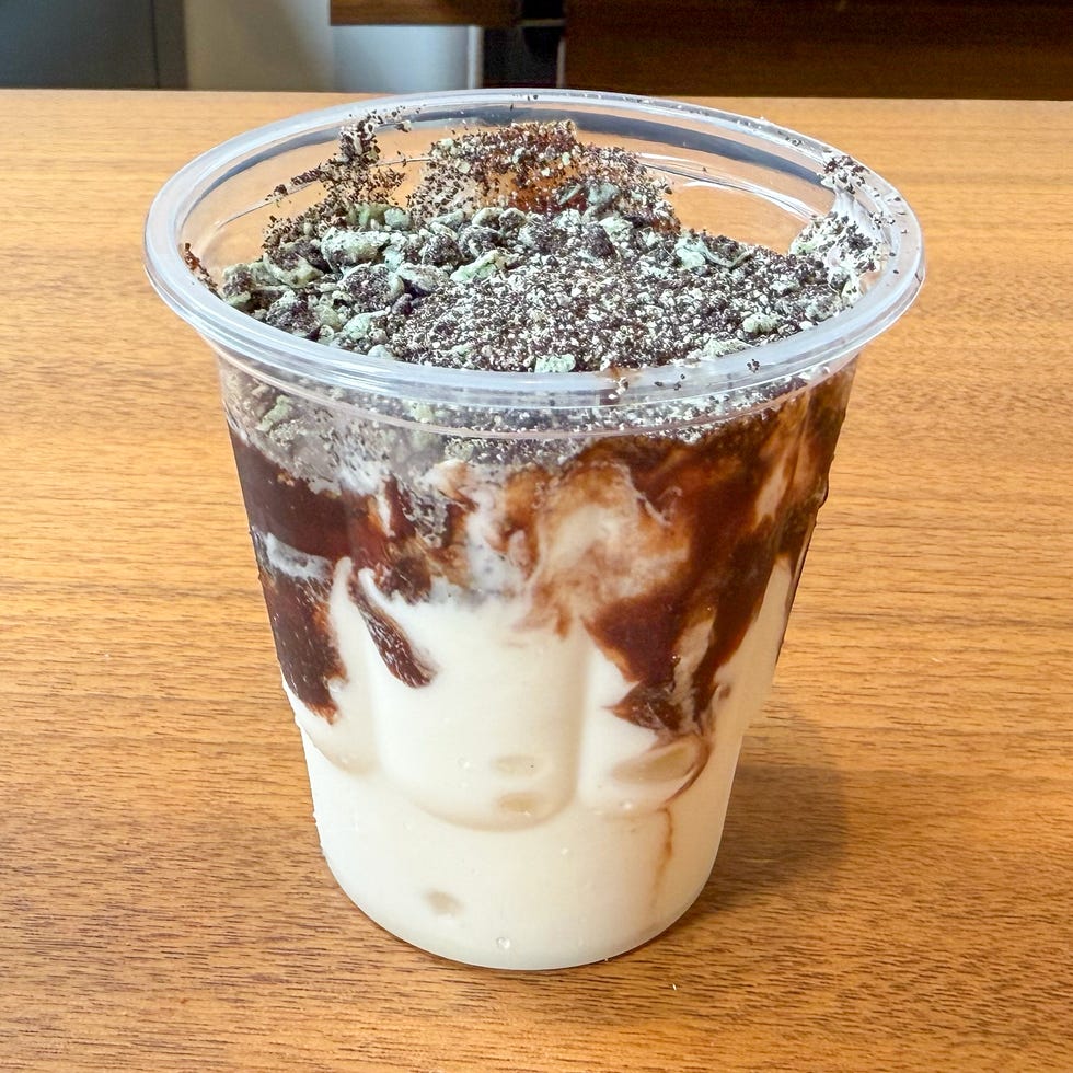 dessert cup with layered mint and chocolate flavors topped with crushed cookies