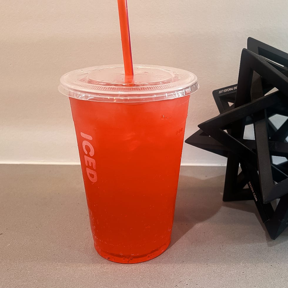 iced beverage in a clear cup next to a decorative object