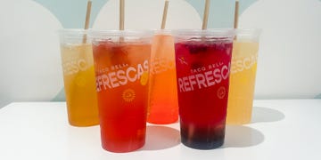 colorful beverage in plastic cups with straws