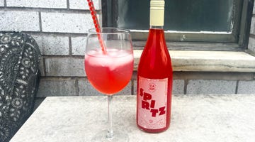 wine glass with cocktail and bottle of spritz