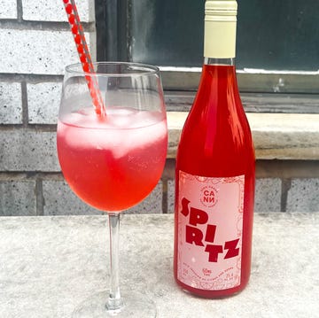 wine glass with cocktail and bottle of spritz wine glass with cocktail and bottle of spritz