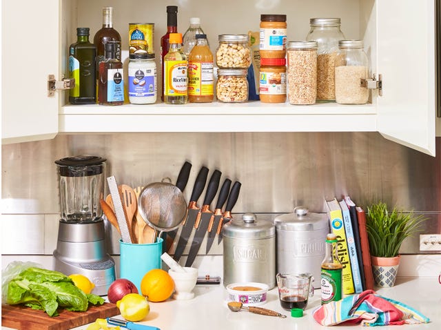 various kitchen items on a counter and in a cabinet