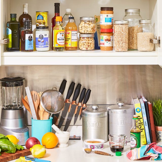 Various kitchen items on a counter and in a cabinet various kitchen items on a counter and in a cabinet