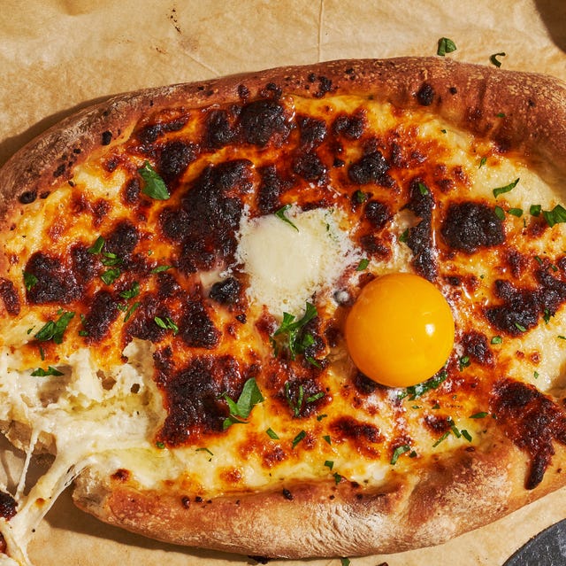Small pizza on parchment paper small pizza on parchment paper