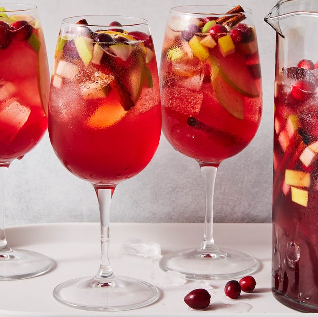 Three glasses of sangria next to a pitcher of sangria three glasses of sangria next to a pitcher of sangria