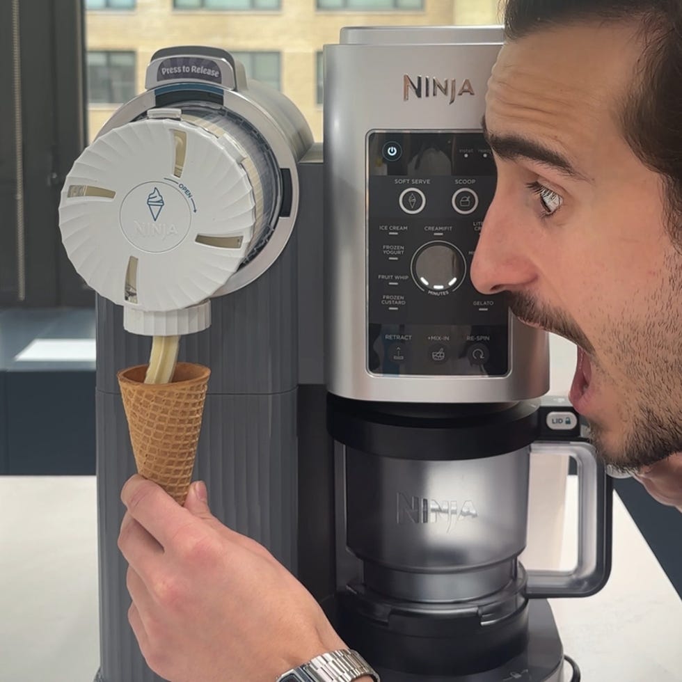 a kitchen appliance dispensing softserve ice cream into a cone