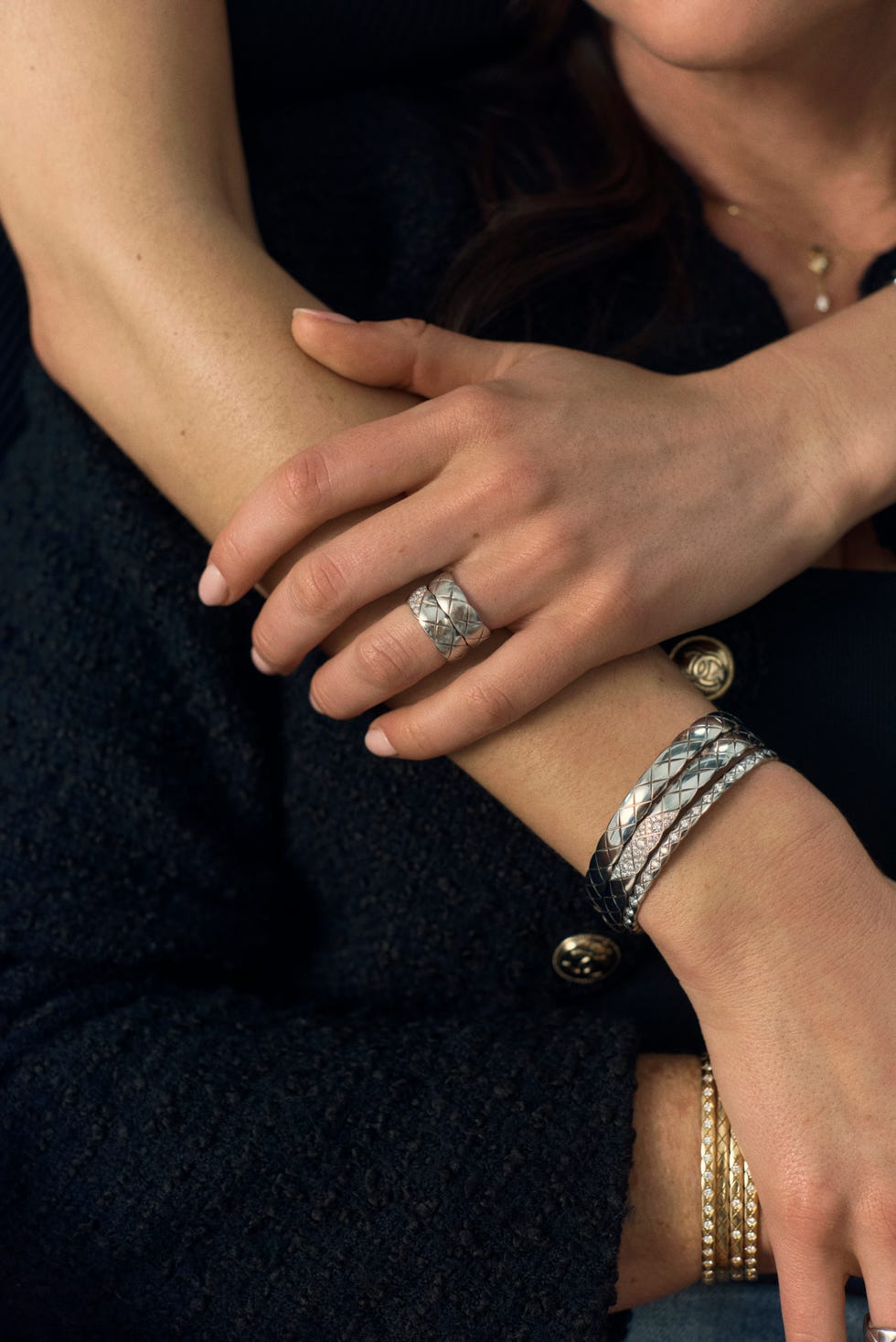 a mother and her daughter model their arm jewelry.
