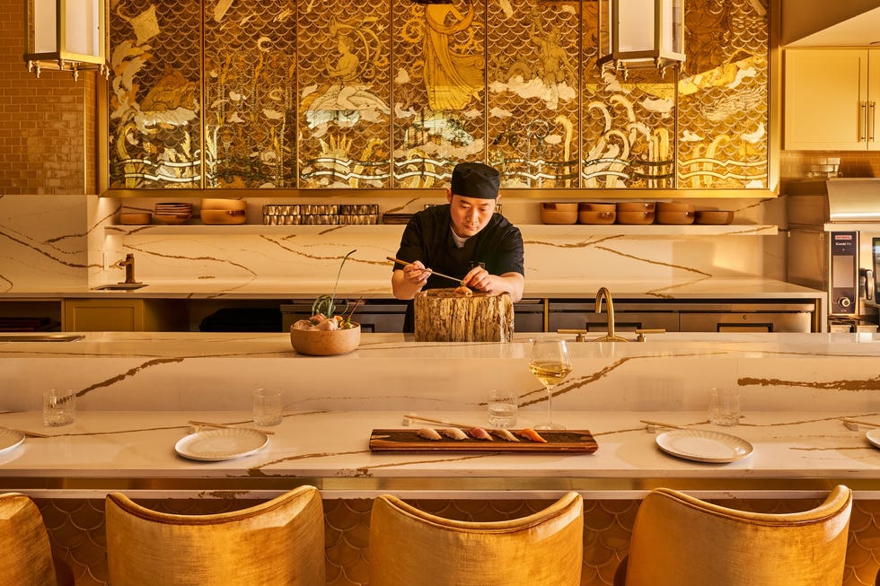 chef preparing sushi at a modern kitchen counter