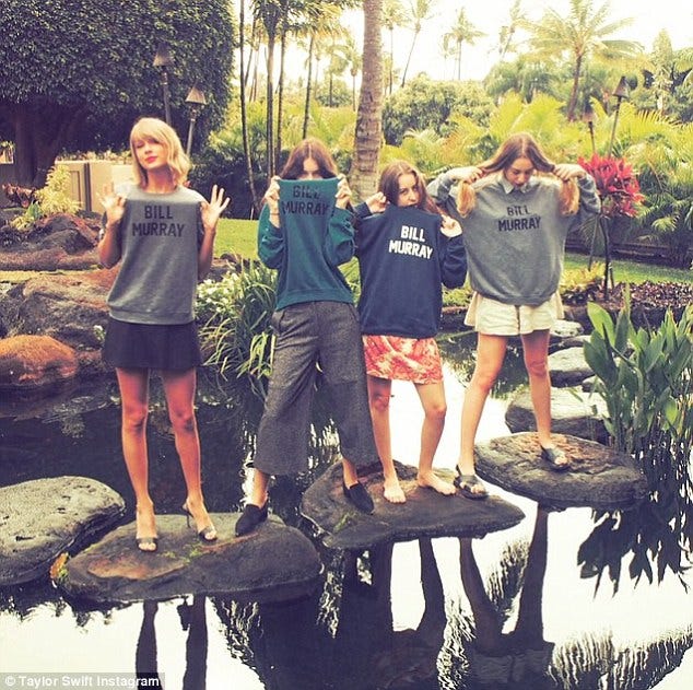 a group of women standing on a table in a garden