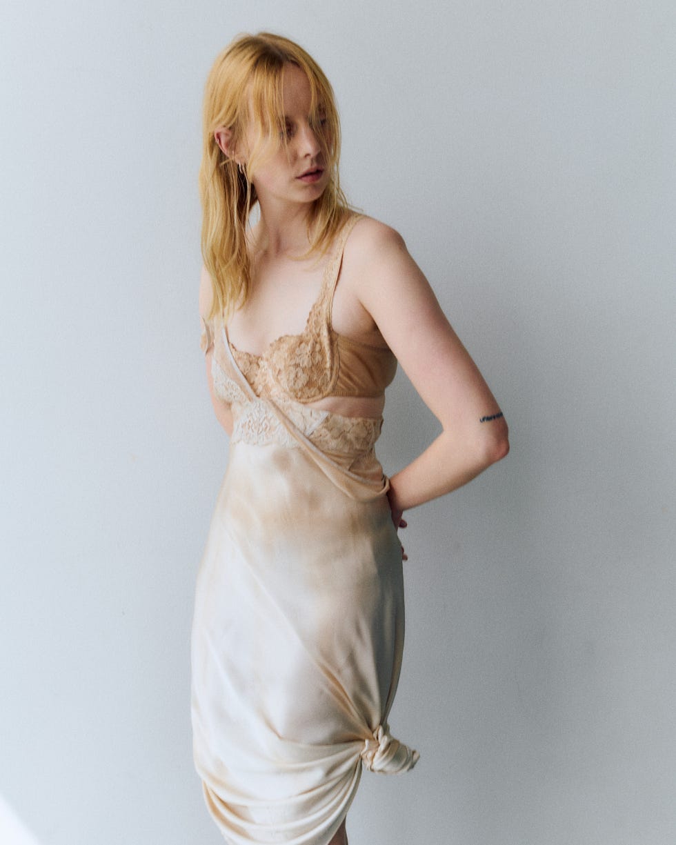 a model poses in a stylish outfit with a neutral palette