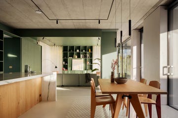 open plan kitchen in new build lake como home featuring wooden table and chairs concrete ceiling