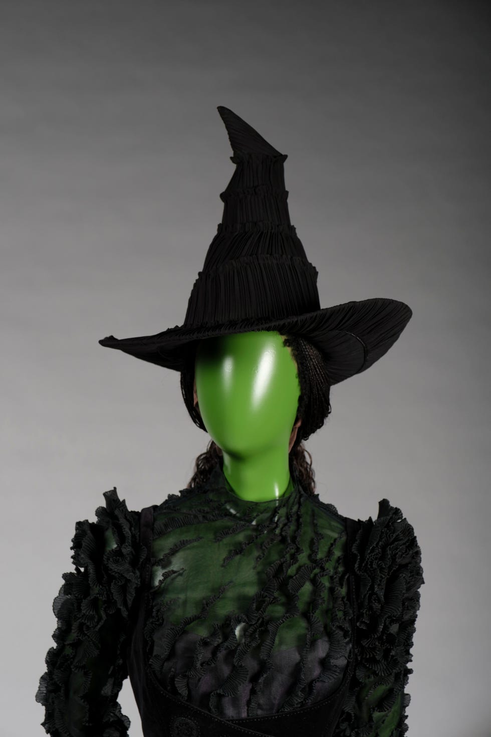 darkthemed outfit with a tall pointy hat and intricate fabric design