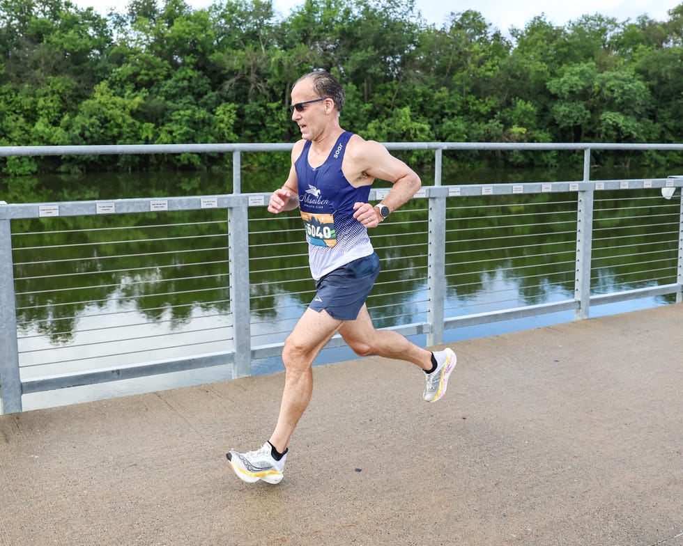 a runner in a race running along a river