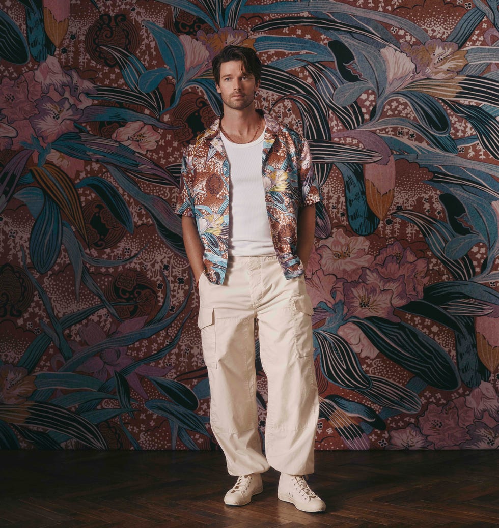 casual male model showcasing tropicalthemed fashion attire against a floral backdrop