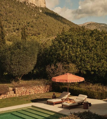 parasol and sun loungers by a pool