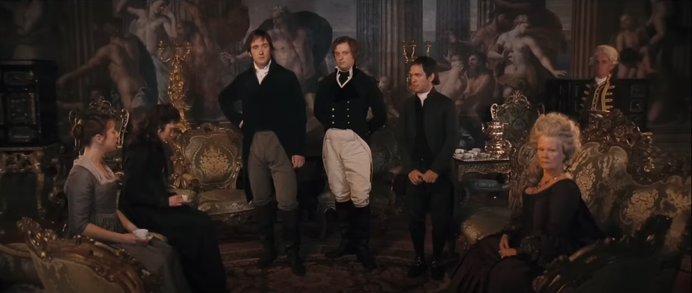 Group of people in formal attire in an ornate historical setting