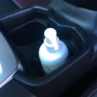 hand sanitizer in car cup holder