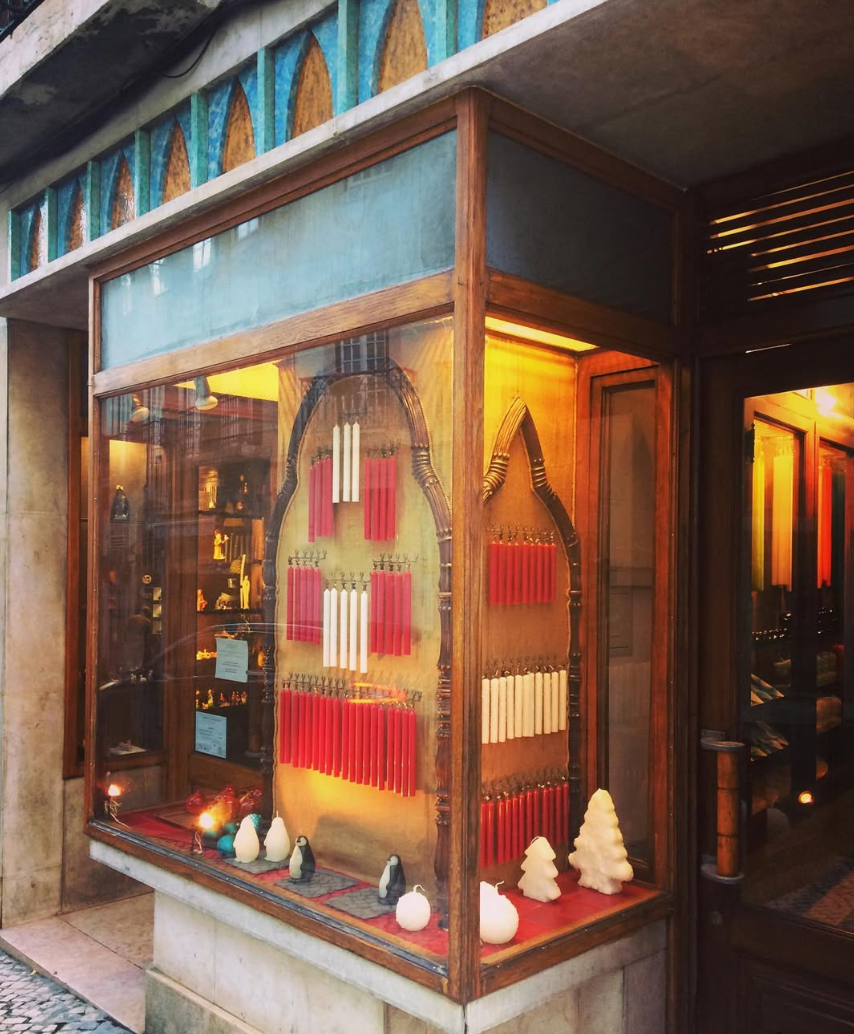 Candle shop display featuring various candles and decorative figures.