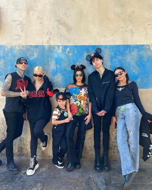 kourtney and travis pose with their kids in black