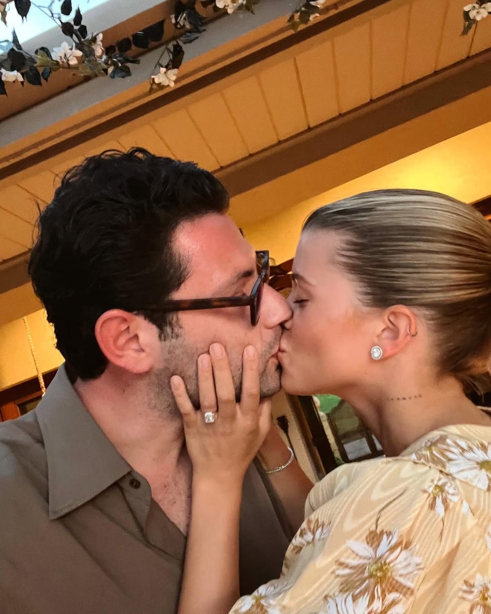 couple interacting closely indoors with a focus on their hands and facial expressions