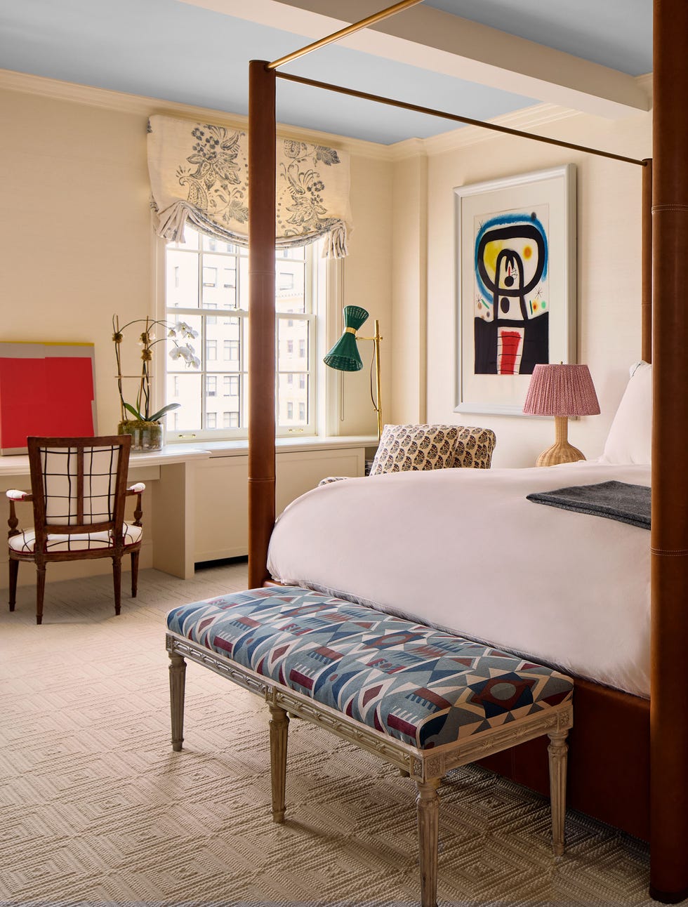 Luxurious bedroom featuring a canopy bed and artistic decor