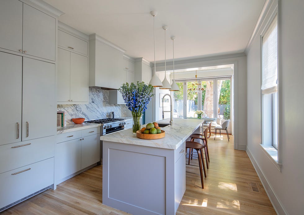 modern kitchen with a marble island and ample natural light