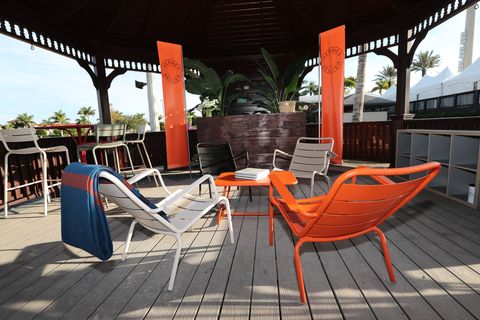 Furniture, Chair, Orange, Architecture, Table, Restaurant, Outdoor furniture, Building, Vacation, Leisure, 