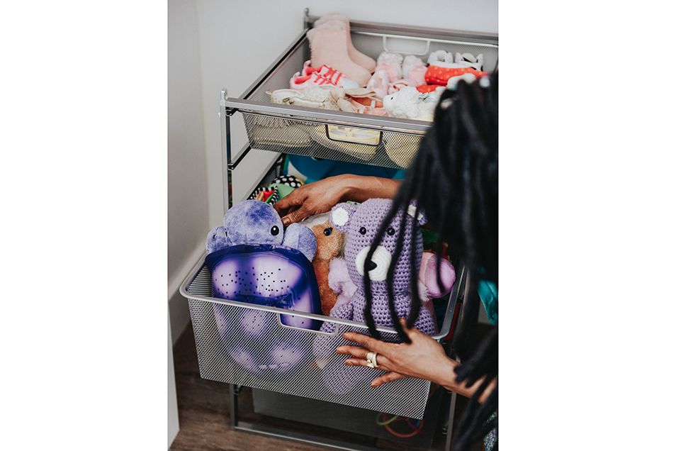 woman looking at bin of toys