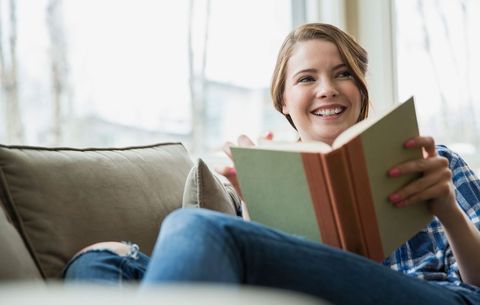 woman reading and smiling