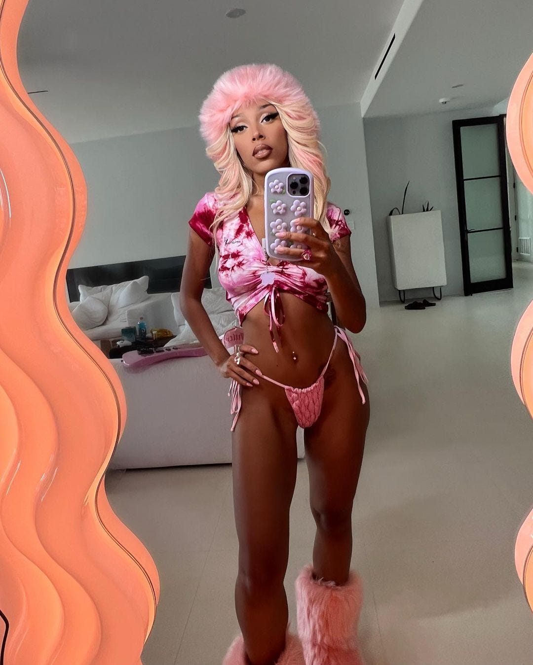 Doja Cat Pairs a Bright Pink Bikini with a Furry Hat and Boots