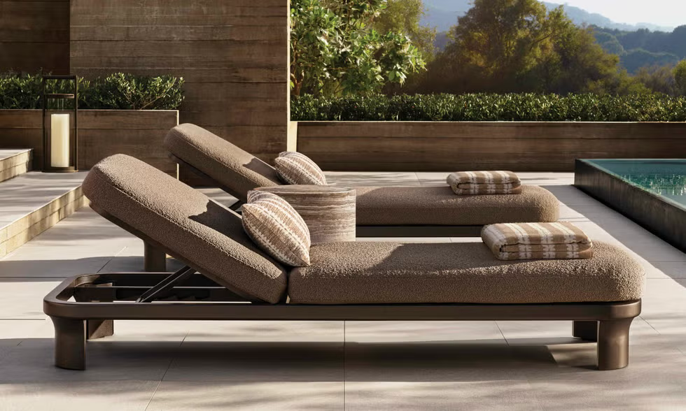Outdoor lounge area with two adjustable loungers and a small table.