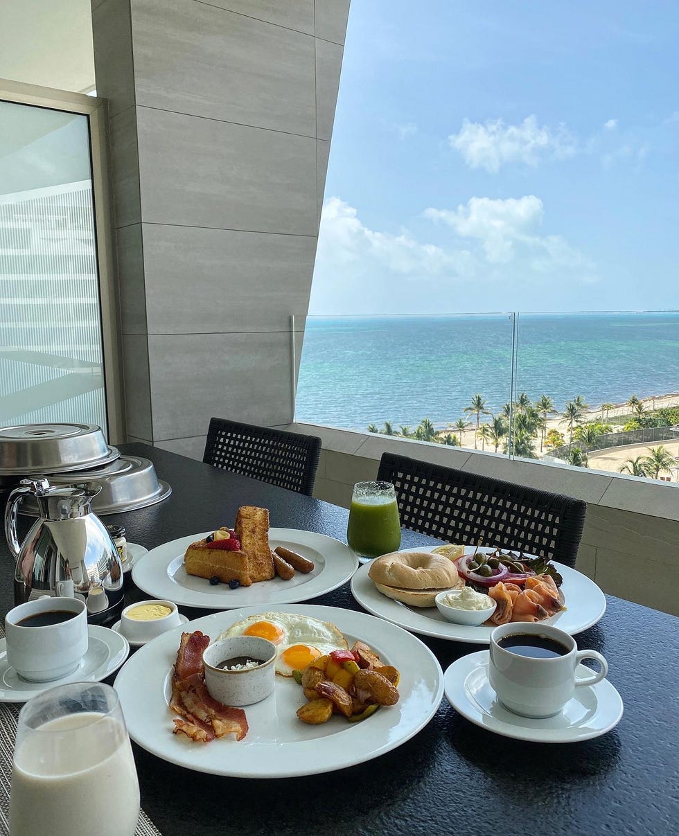 breakfast spread on a balcony with an ocean view