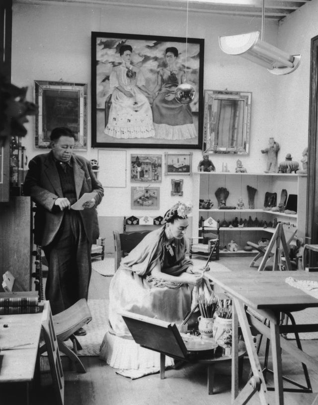 Diego Rivera and Frida Kahlo read and work in a studio