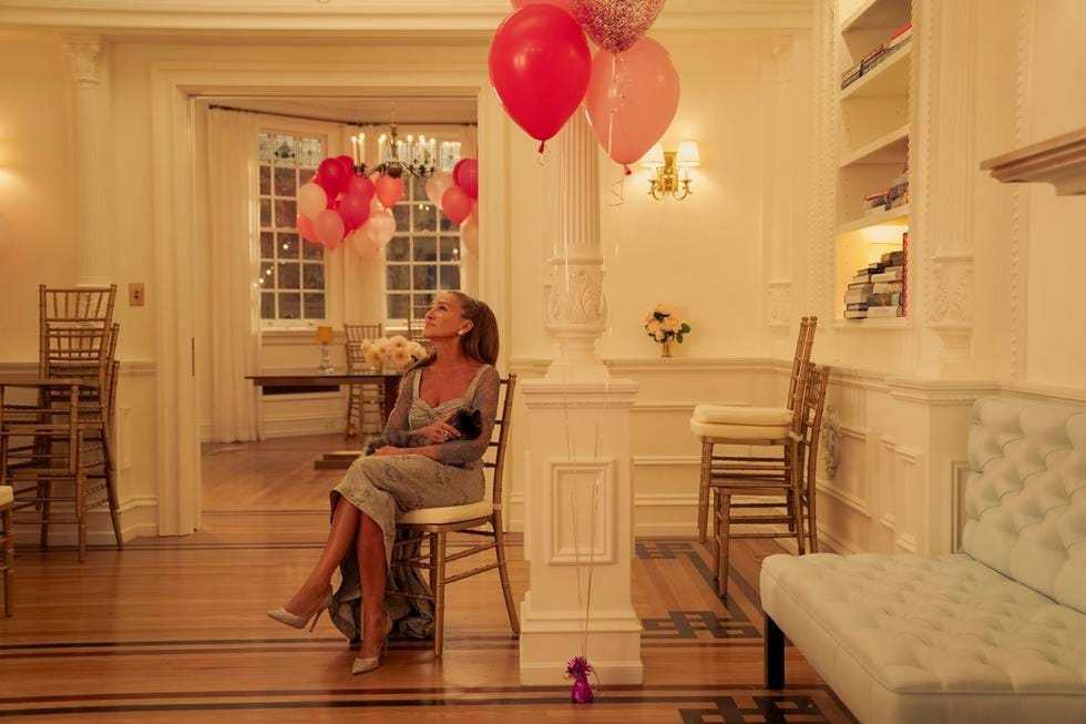 A festive indoor setting with balloons and soft seating.