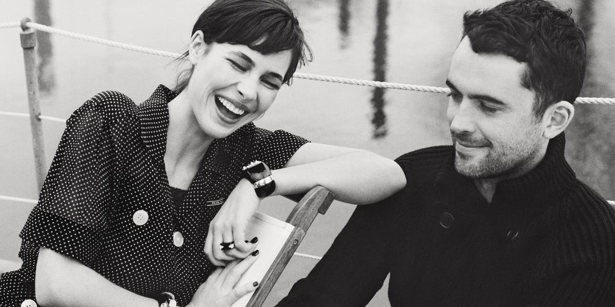 A couple resting on a boat deck, elegantly dressed and relaxed. A couple resting on a boat deck, elegantly dressed and relaxed.