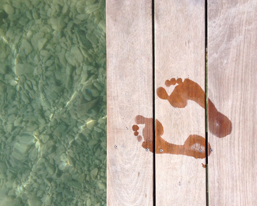 Directly Above Shot Of Footprints On Pier Over Lake