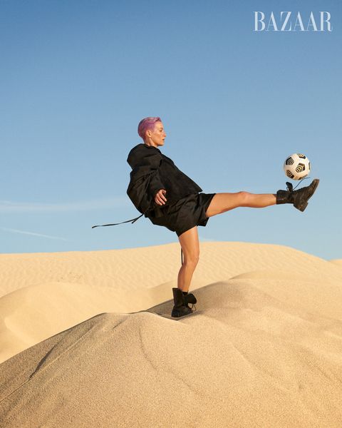 megan kicks soccer ball on sand dune