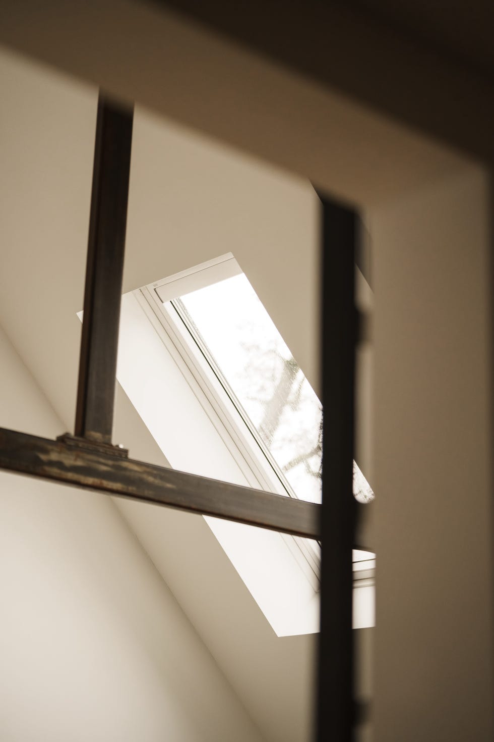 a velux roof window skylight from an angle through a railing in the factory house in muiden, the netherlands