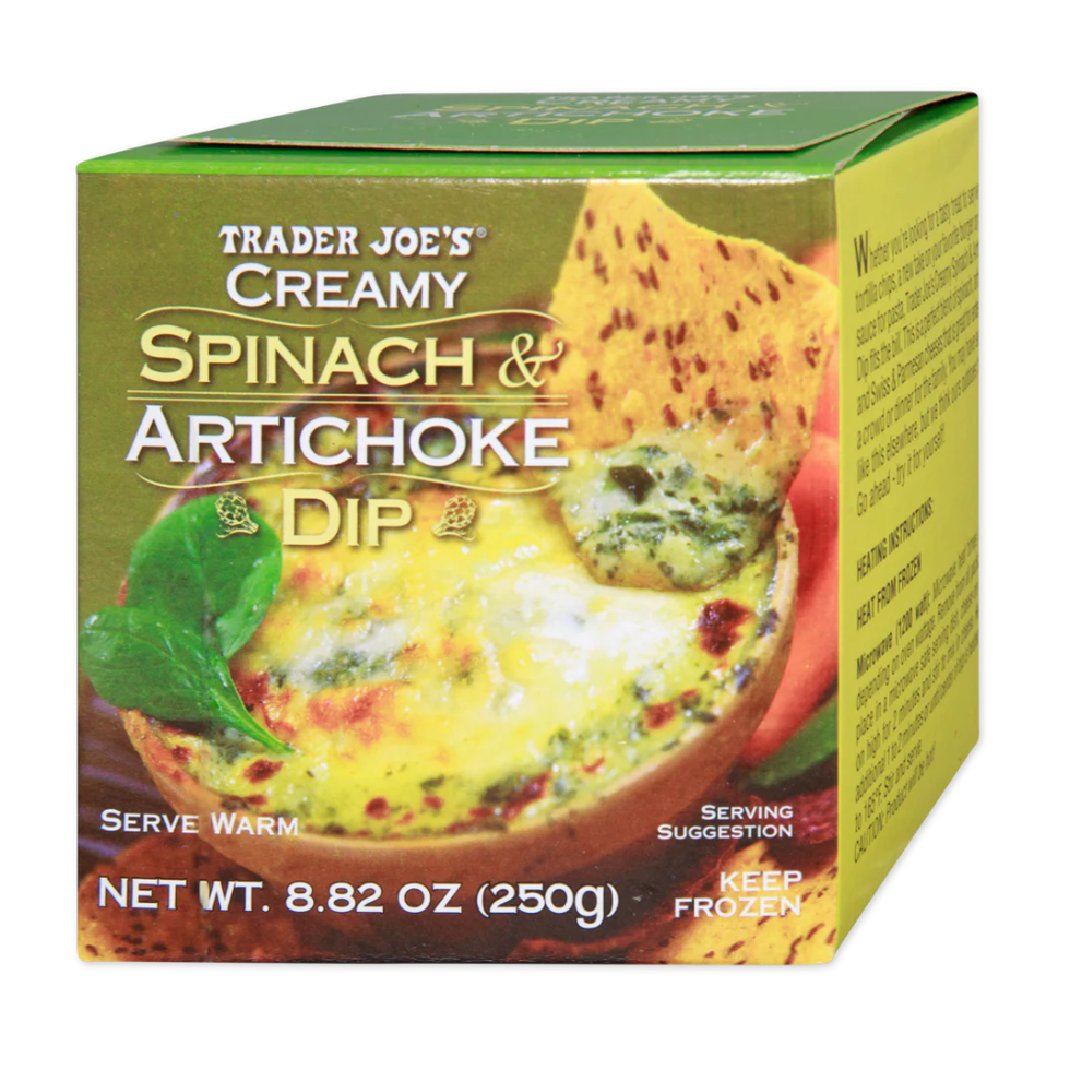 a green box containing creamy spinach and artichoke dip