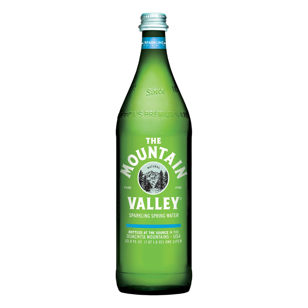 green glass bottle of sparkling spring water labeled mountain valley