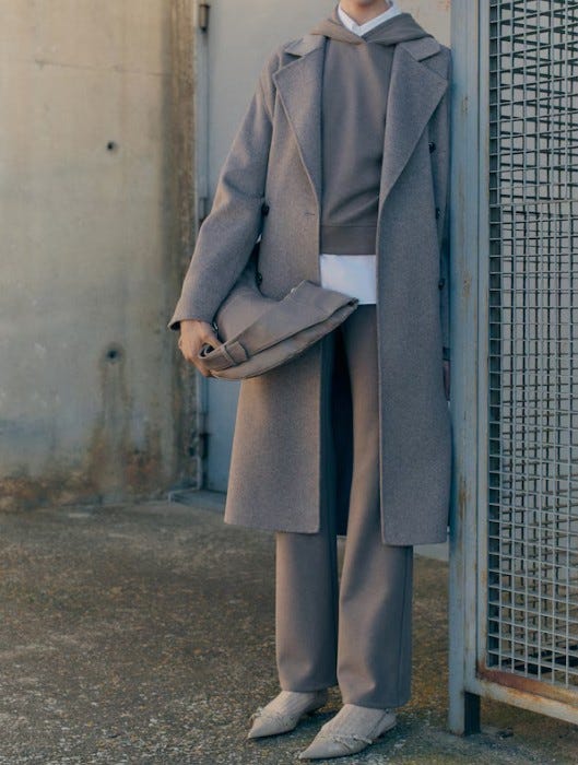 fashionable outfit featuring layers of neutralcolored garments