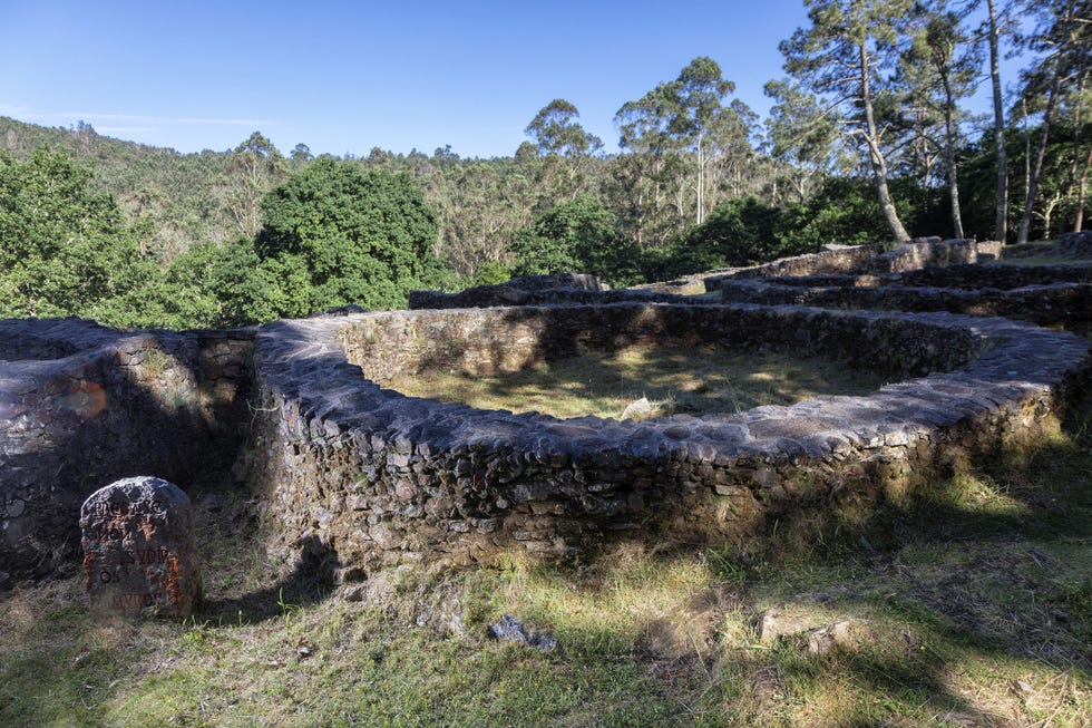 a stone bridge over a grassy area
