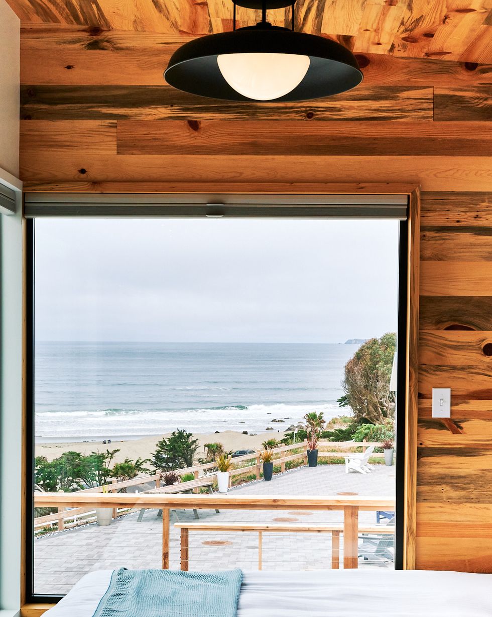 a room with a view of the ocean and a deck