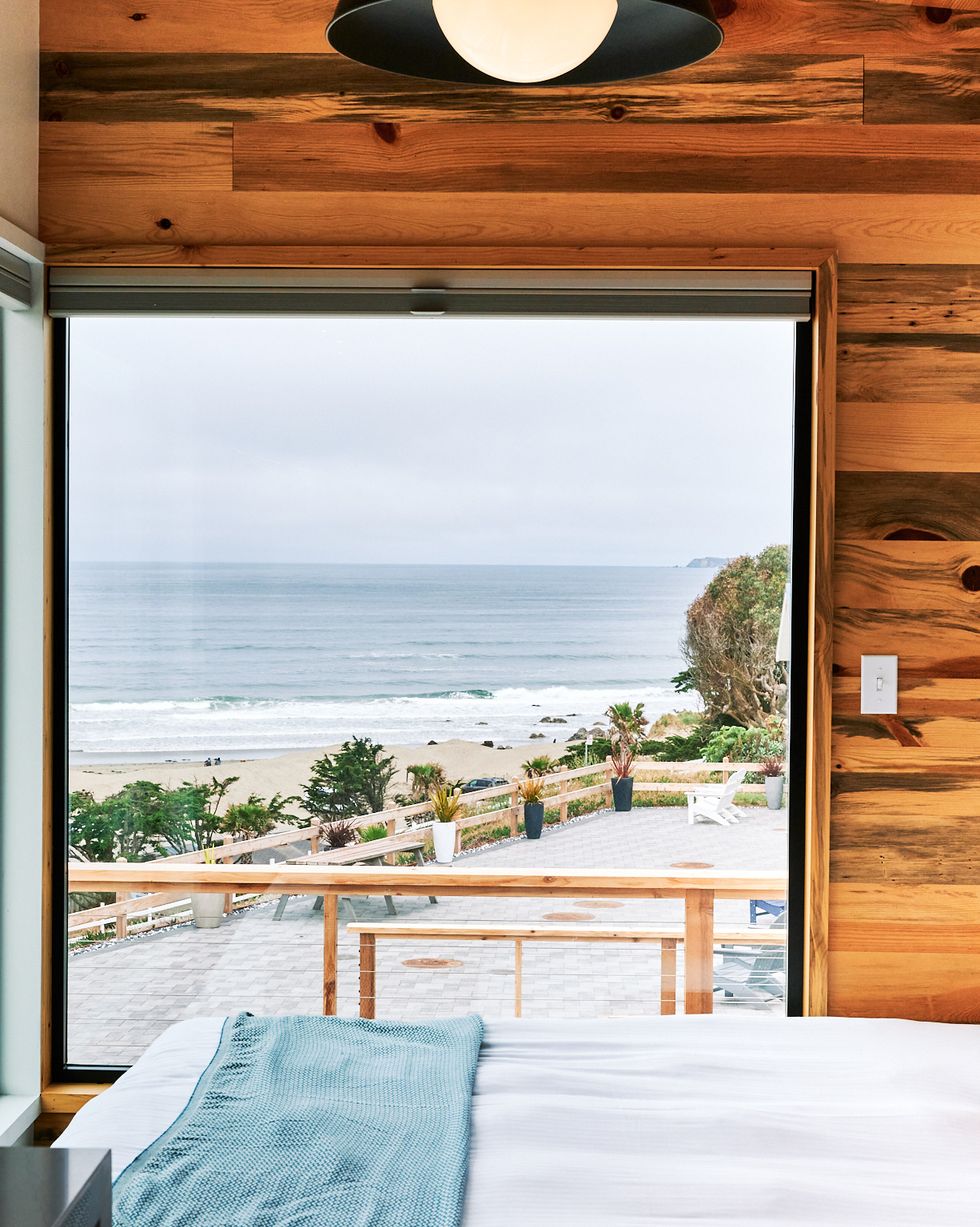 a room with a view of the ocean and a deck